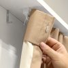 Close up of a drapery with a Fabtex stainless steel drapery pin. The drapery pin is latched on to the carriers along a drapery track.