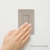 Hand operating a wall switch showing the beige Fabtex momentary contact rocker switch.